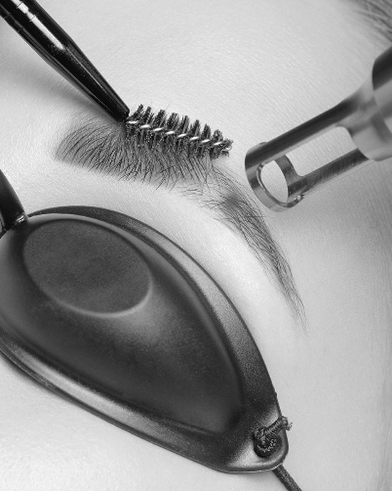 Laser eye shields, brow brush and laser handpiece set up for an eyebrow tattoo removal session at Bowbowbrow